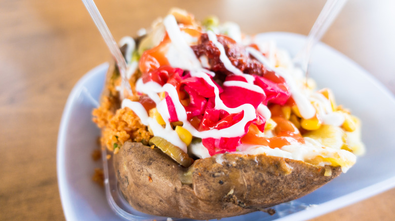 The baked potato filled with corn, jalapenos, sour cream, and other toppings