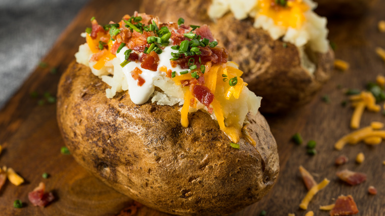 Loaded baked potato with cheese, sour cream, chives and bacon