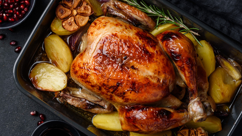 roast turkey in a pan with vegetables