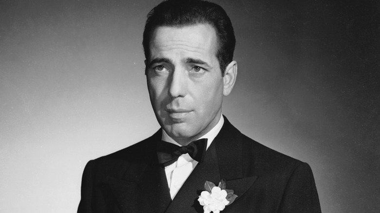 a black and white photo of Humphrey Bogart in a tuxedo