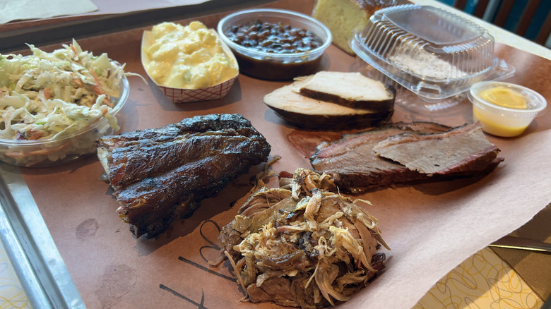 Barbecue meats and sides on paper-lined tray at Sugarfire Smokehouse