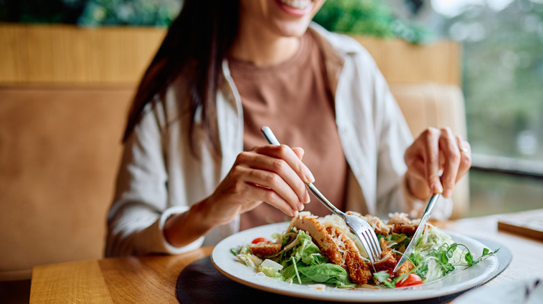woman dining solo and smiling