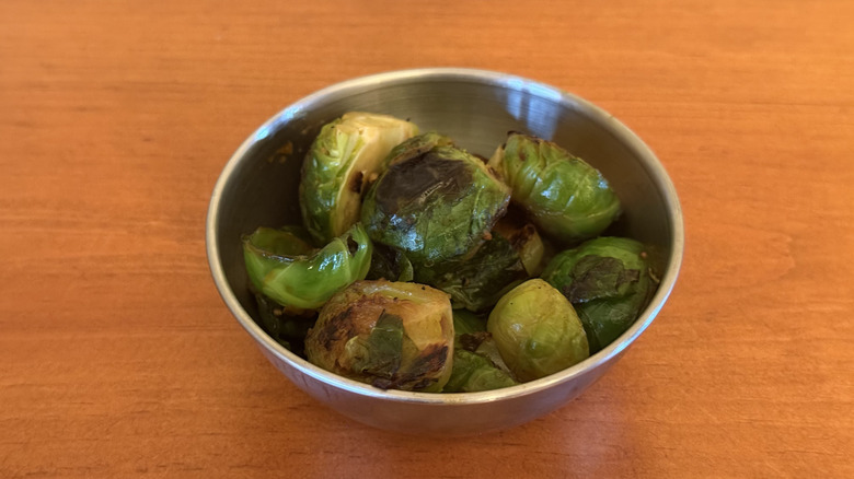 Stainless steel bowl with braised Brussels sprouts