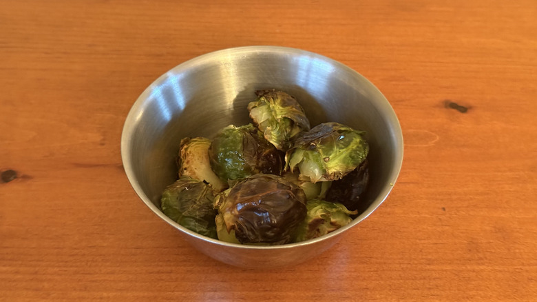 Stainless steel bowl with roasted Brussels sprouts