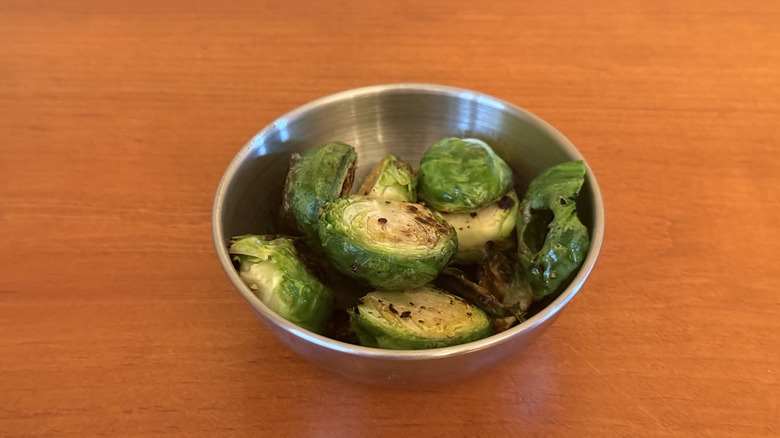 Stainless steel bowl with sautéed Brussels sprouts