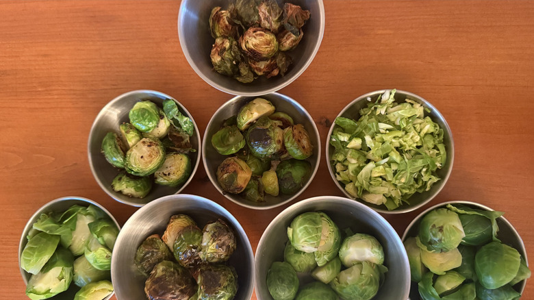 Eight bowls of Brussels sprouts prepared using different methods
