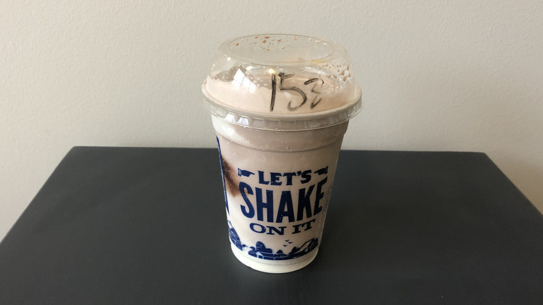Culver's chocolate shake in plastic cup.
