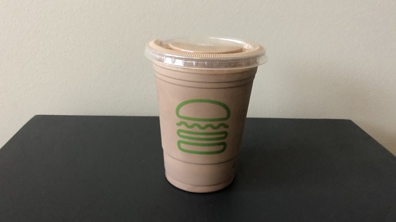 Shake Shack chocolate shake in plastic cup.