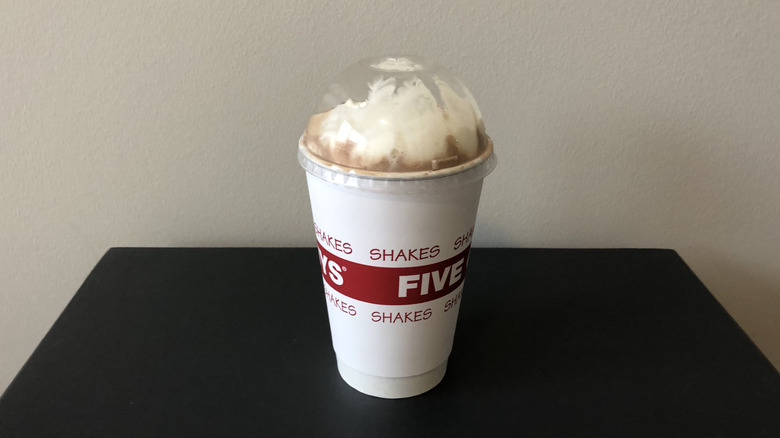 Five Guys chocolate milkshake with whipped cream.