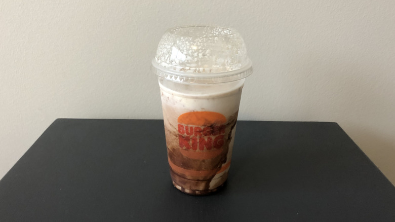 Burger King chocolate shake in plastic cup.
