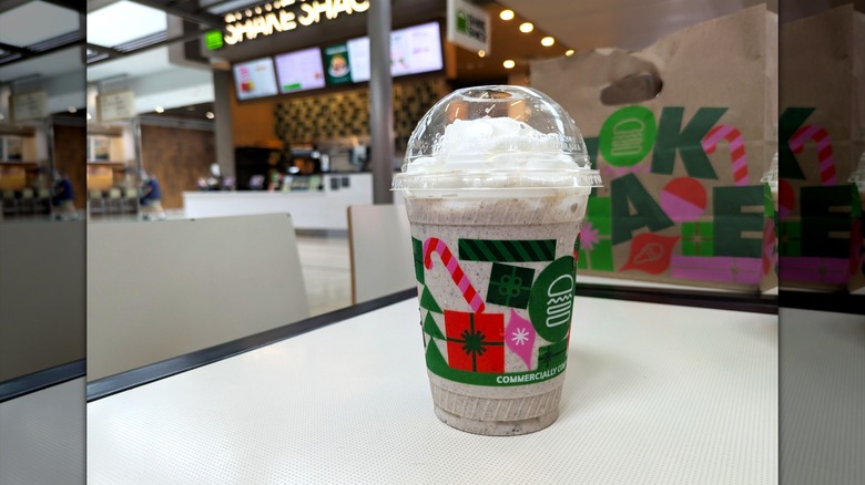 Chocolate crème-filled cookies are crushed and mixed with vanilla custard in a disposable cup topped with whipped cream