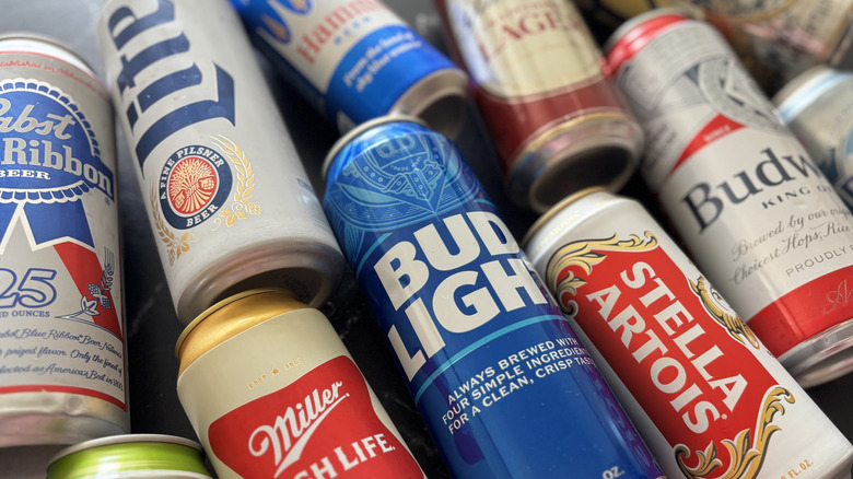 Close up of various beer cans on countertop