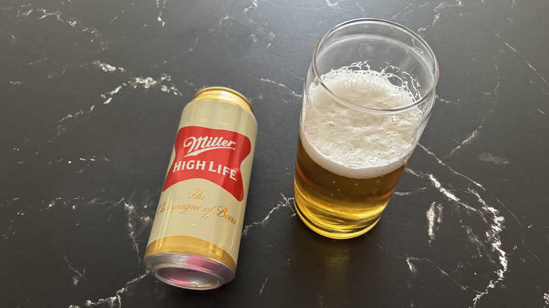 A can Miller High Life with a foamy glass of beer next to it