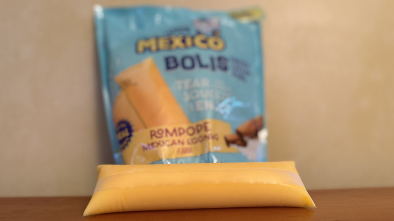 Boli in front of package on wooden table