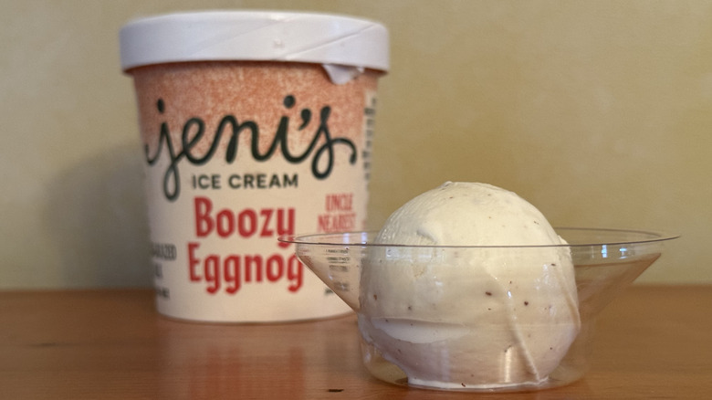 Scoop of ice cream in front of Jeni's carton