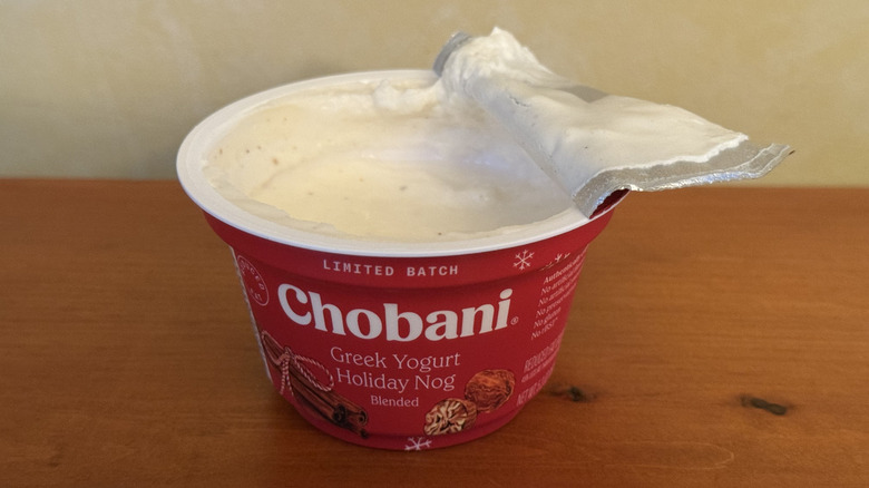 Open container of Chobani yogurt on wooden table