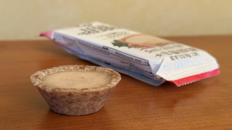 Hail Merry cup in front of package on wooden table