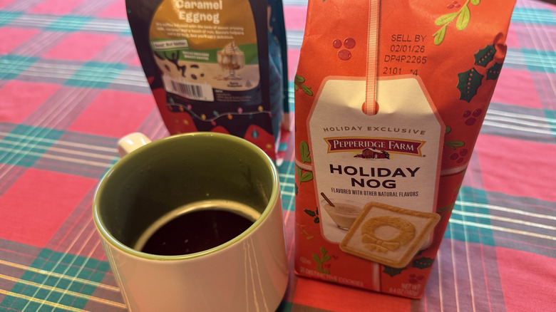 Cup of coffee beside bag of grounds and bag of cookies