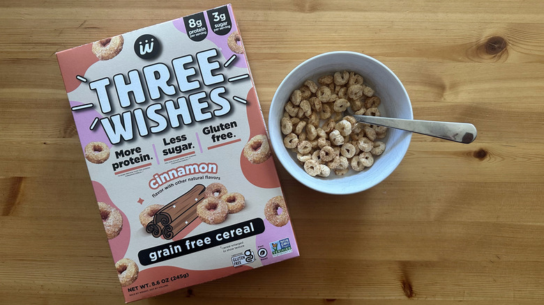 Three Wishes Cinnamon cereal in white bowl on table next to the whole box