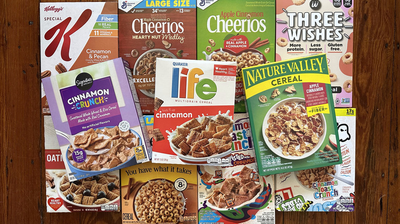 Cinnamon-flavored cereal boxes arranged on wooden background