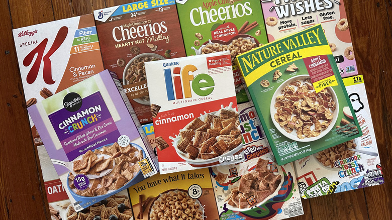 Cereal boxes of cinnamon-flavored varieties arranged on wooden background