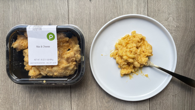 Macaroni and cheese in container and on plate with spoon