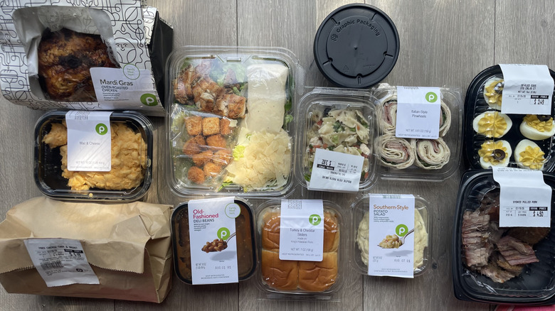 Assorted collection of prepared foods from Publix on a wooden surface