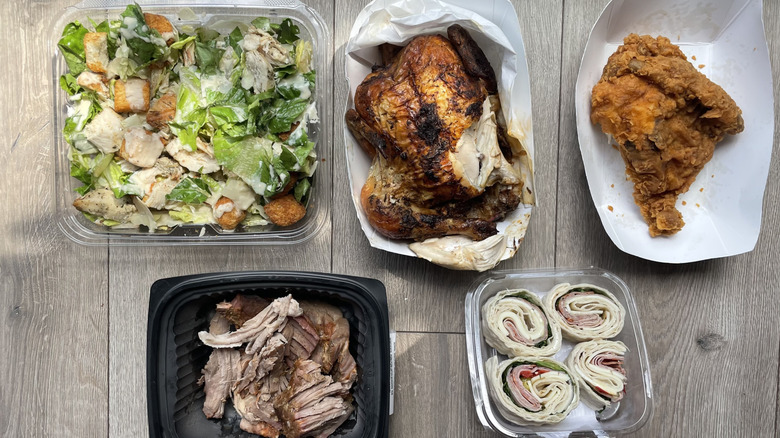 Assorted Publix prepared foods laid out on wooden surface