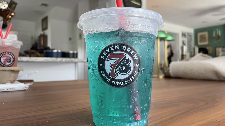 Sour gummy worm soda in a cup on a table