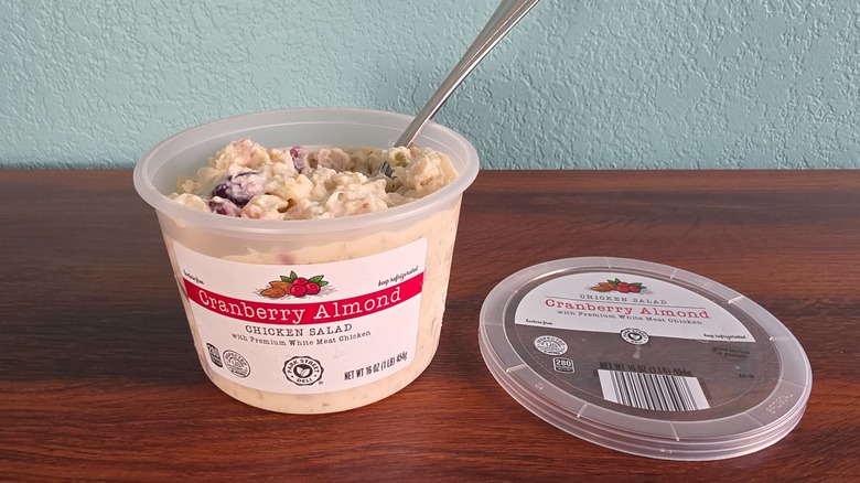 Container of Park Street deli cranberry almond chicken salad open on table with spoon