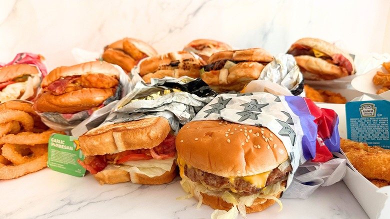 Lots of sandwiches from Carl's Jr. on white table