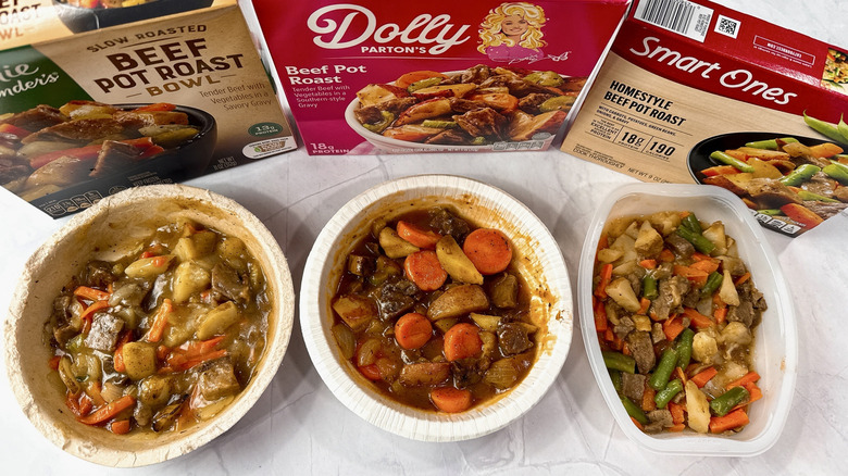 Frozen pot roast meal boxes and trays from three different brands on a countertop