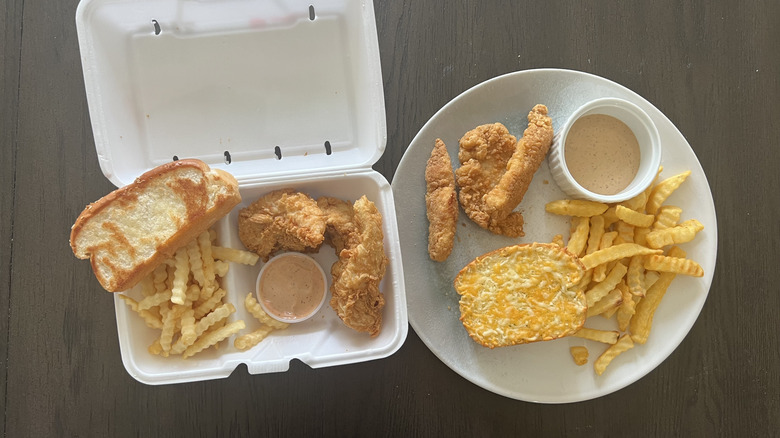 Raising Cane's chicken meal in a takeout container and Great Value chicken meal on a plate placed side by side
