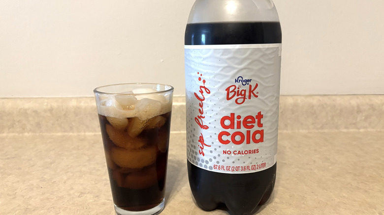Diet Big K in 2 liter and glass on neutral countertop