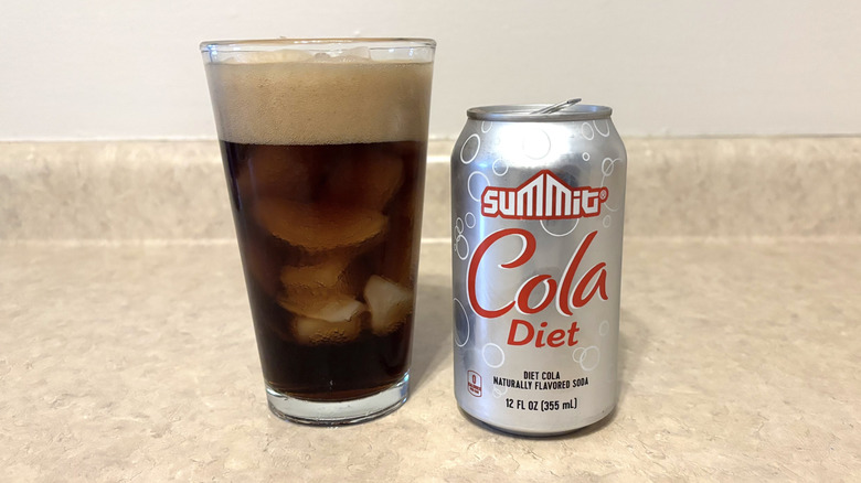 Summit diet cola in glass and can on a neutral countertop