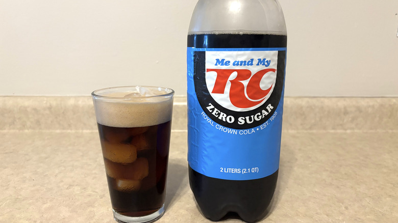 RC cola zero in 2 liter and glass on neutral countertop