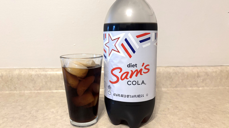 Sam's diet cola in 2 liter and glass on neutral countertop