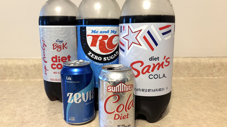 A variety of diet sodas on a neutral background