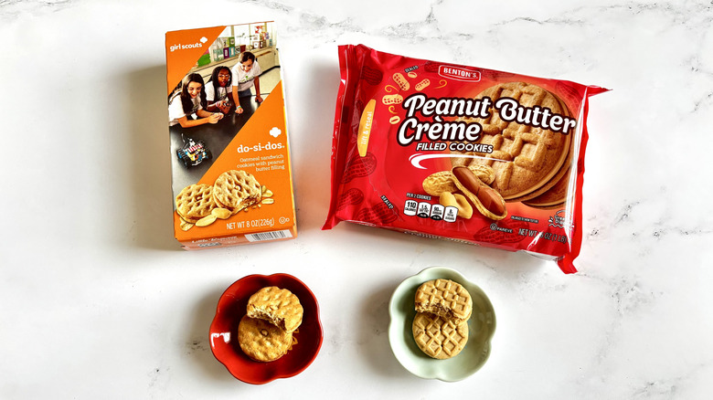 Girl Scout Do-Si-Dos cookie box next to Aldi peanut butter cookie package with cookies on plates in front
