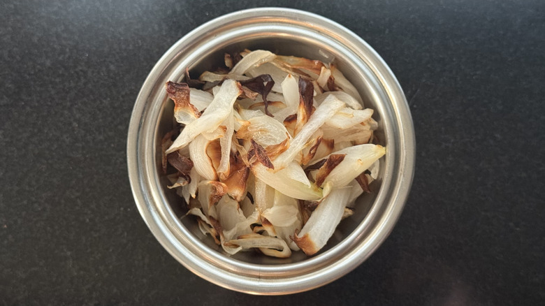 Stainless steel bowl of caramelized onions cooked in air fryer
