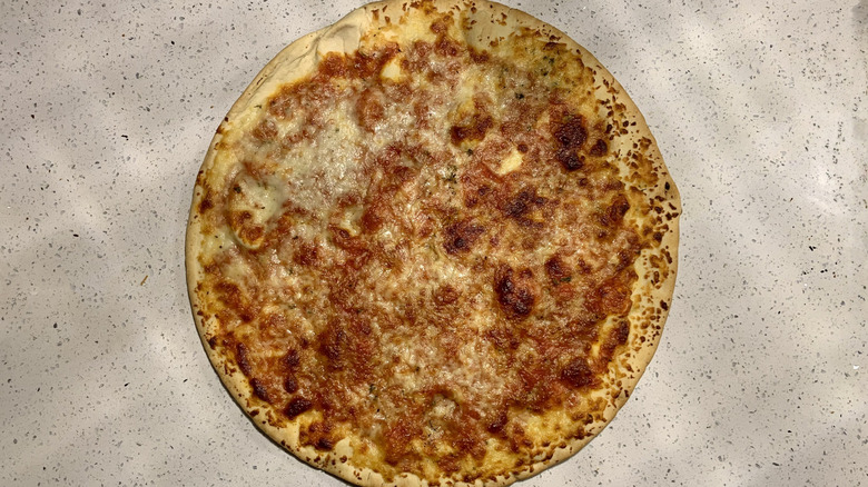 Baked Lidl cheese pizza on top of white granite countertop