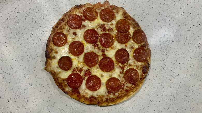 Baked Target pepperoni pizza on top of white granite countertop