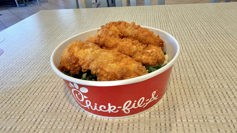 3-count chicken strip meal with kale crunch salad in a bowl
