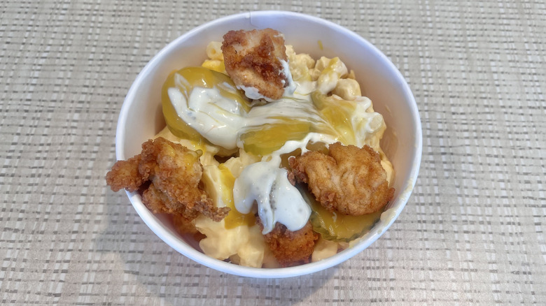 View of loaded nachos with chicken and pickles