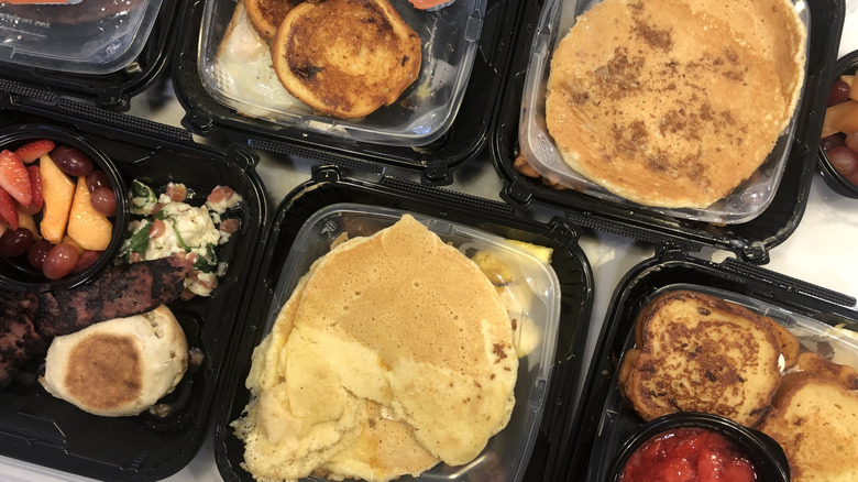 seven different Denny's Slam meals in to-go containers