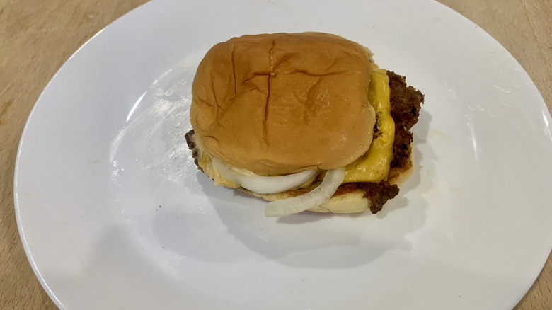 Shake Shack burger on white plate on wood table