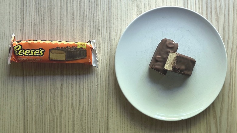Reese's Crunchy Peanut Ice Cream Bar on white plate and a wrapper on the side