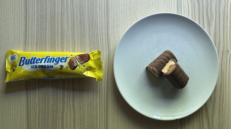 Butterfinger Ice Cream Bar on white plate with a wrapper next to it