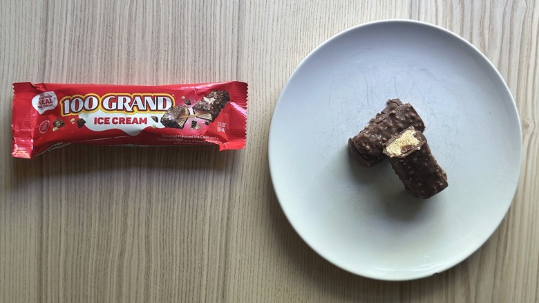 100 Grand Ice Cream Bar wrapper with the bar sliced in half and served on a white plate