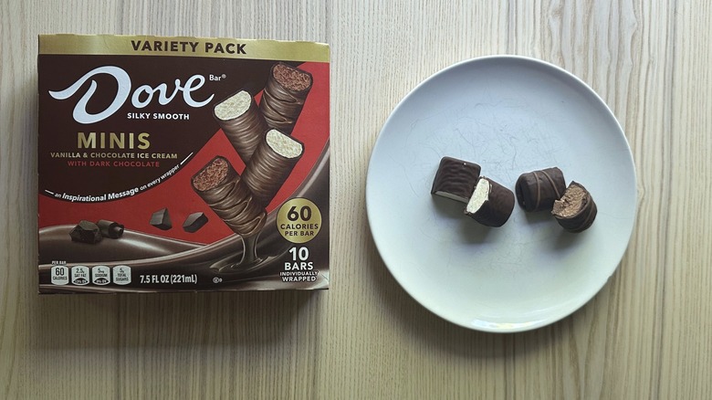 Dove Dark Chocolate Minis Ice Cream Bars sliced in half on a plate and a box on the side